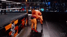 two men are wrestling in a wrestling ring with the words nxt live on the bottom of the screen .