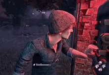 a person wearing a beanie is standing in front of a brick wall .