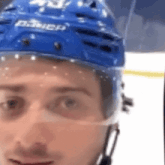 a hockey player wearing a blue helmet with the word daner on it