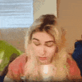 a blurry picture of a woman with her eyes closed and her hair in a bun