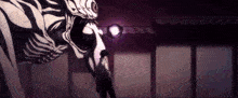 a man is standing in front of a giant monster with a purple light coming out of its mouth .