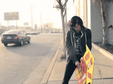 a man holding a sign that says ' now you can '