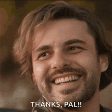 a man with a beard is smiling with the words thanks pal behind him