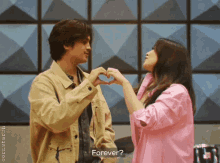 a man and a woman are making a heart shape with their hands and the woman is asking if they are forever