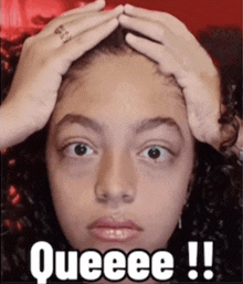 a girl with curly hair is holding her head with the words queeee !! above her