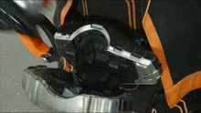 a close up of a motorcycle engine with a black and orange stripe