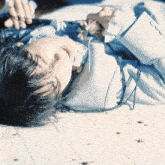 a woman in a blue dress is laying on a tiled floor