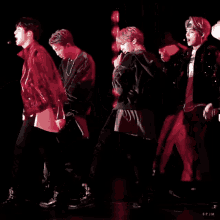 a group of people are dancing in a dark room with the letters spjm on the bottom right corner