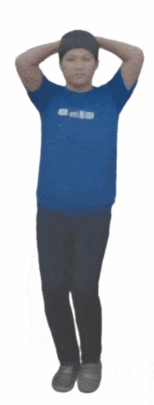 a person wearing a blue shirt that says ' a ' on it is standing with their hands behind their head