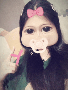 a girl with a pacifier in her mouth and a pink bow on her head