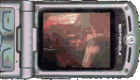 a motorola flip phone is open and shows a picture