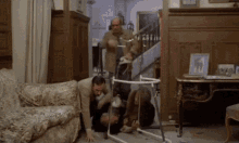 a group of men are playing with a walker in a room