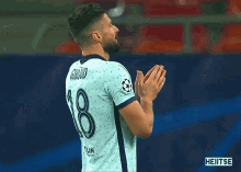 a soccer player wearing a shirt with the number 3 on it