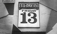 a black and white photo of a calendar that says friday 13