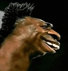 a close up of a man 's face with a mohawk and a very large nose .