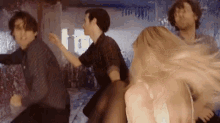 a group of people are dancing in a room with a sign that says ' i 'm ' on it