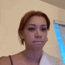 a woman is making a silly face in front of a window