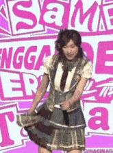 a girl in a school uniform is dancing in front of a sign that says ' sama '