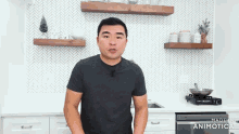a man is standing in a kitchen with the words made in animatica on the bottom right