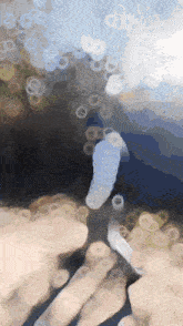 a blurry picture of a person 's fingers and a bottle