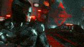 a man in a batman costume is standing in a room