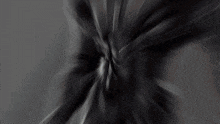 a blurred image of a person 's face with a blue background