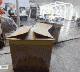 a cardboard box in a garage with a $ 5000 sticker on it