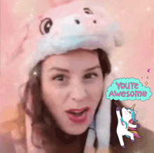 a woman wearing a unicorn hat with the words you 're awesome above her