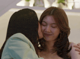 a woman kissing another woman 's cheek with a caption that says lingorm@us