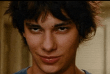 a close up of a young man 's face with his eyes closed