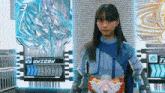 a girl stands in front of a unibon card