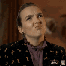 a woman wearing a jacket with horses on it has a bbc america logo on her jacket