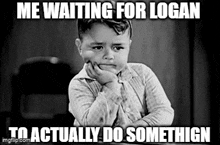 a little boy is sitting at a table with his hand on his chin and making a sad face .