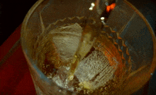 a close up of a glass of liquid with bubbles in it