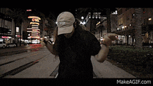 a man is dancing on the sidewalk in front of a cvs store