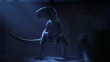 a dinosaur standing in a dark room with a blue light behind it