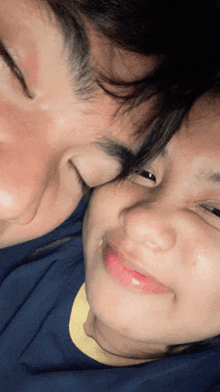 a close up of a woman 's face with a man 's face behind her