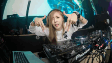 a woman is making a funny face behind a pioneer mixer