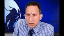 a man in a striped shirt and tie is wearing ear buds in front of a globe