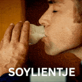 a man drinking from a bottle with soylietje written on the bottom right