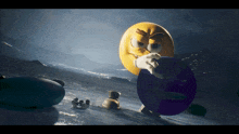 a yellow smiley face holding a blue ball in a snowy scene