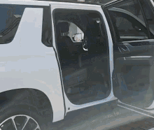 a white suv with the door open and the rear seats folded