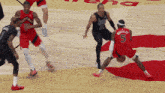 a basketball player with the number 5 on his jersey dribbles the ball