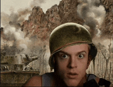 a man wearing a helmet looks surprised in front of a battle scene