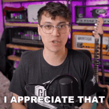 a man standing in front of a microphone with the words i appreciate that behind him