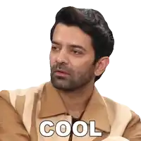 a man with a beard is wearing a brown and white jacket and the word cool is on his face