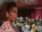 a woman stands in front of a crowd with the number 10 visible