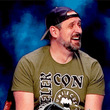 a man wearing a baseball cap and a green shirt that says beer con on it