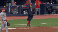 a baseball player wearing a jersey that says cardinals is running on the field