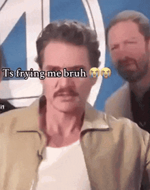 a man with a mustache is standing in front of a sign that says ts frying me bruh